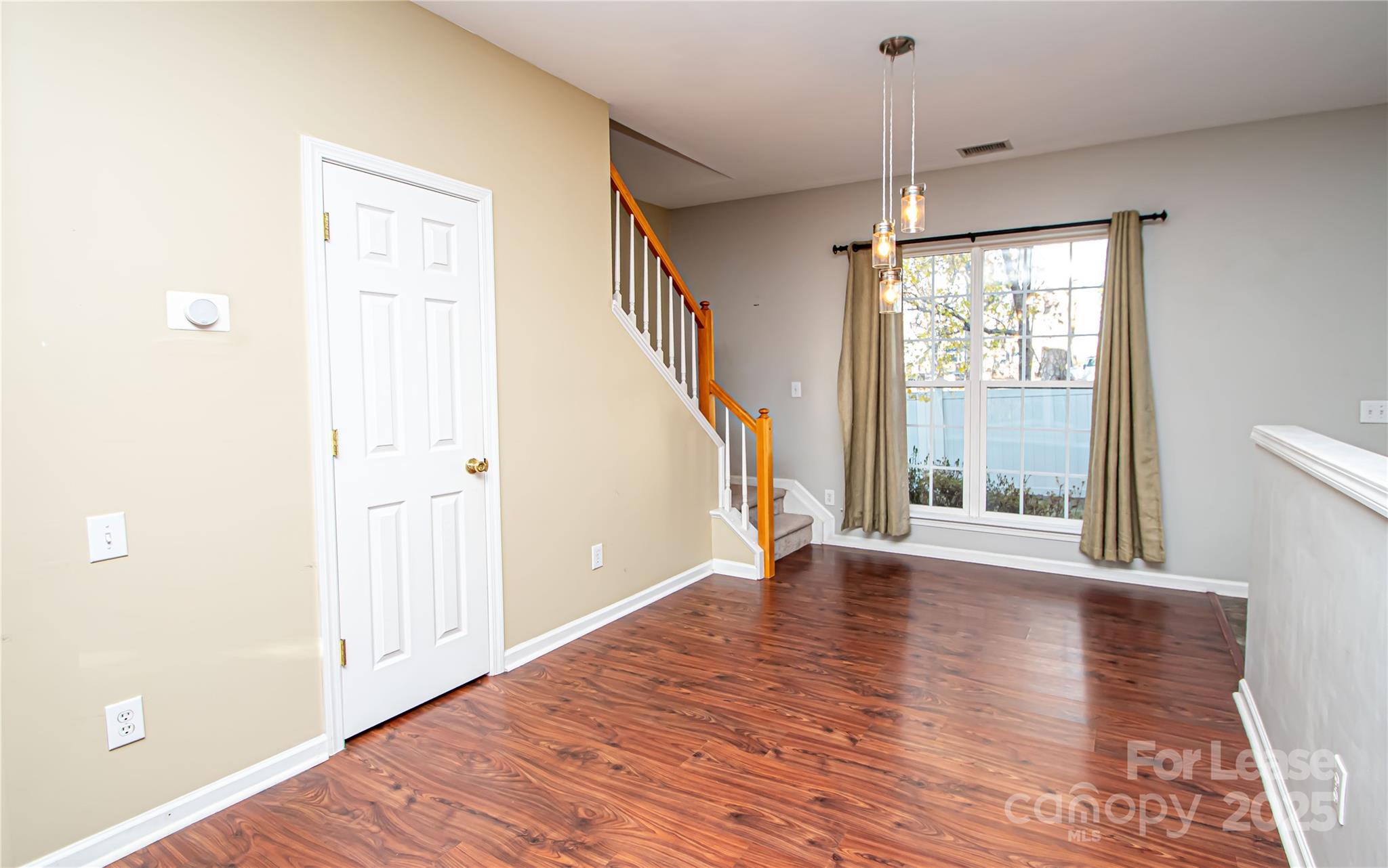 2121 Kaybird Lane Charlotte, NC 28270 - Photo 10 of 39 a view of an empty room with wooden floor and a window
