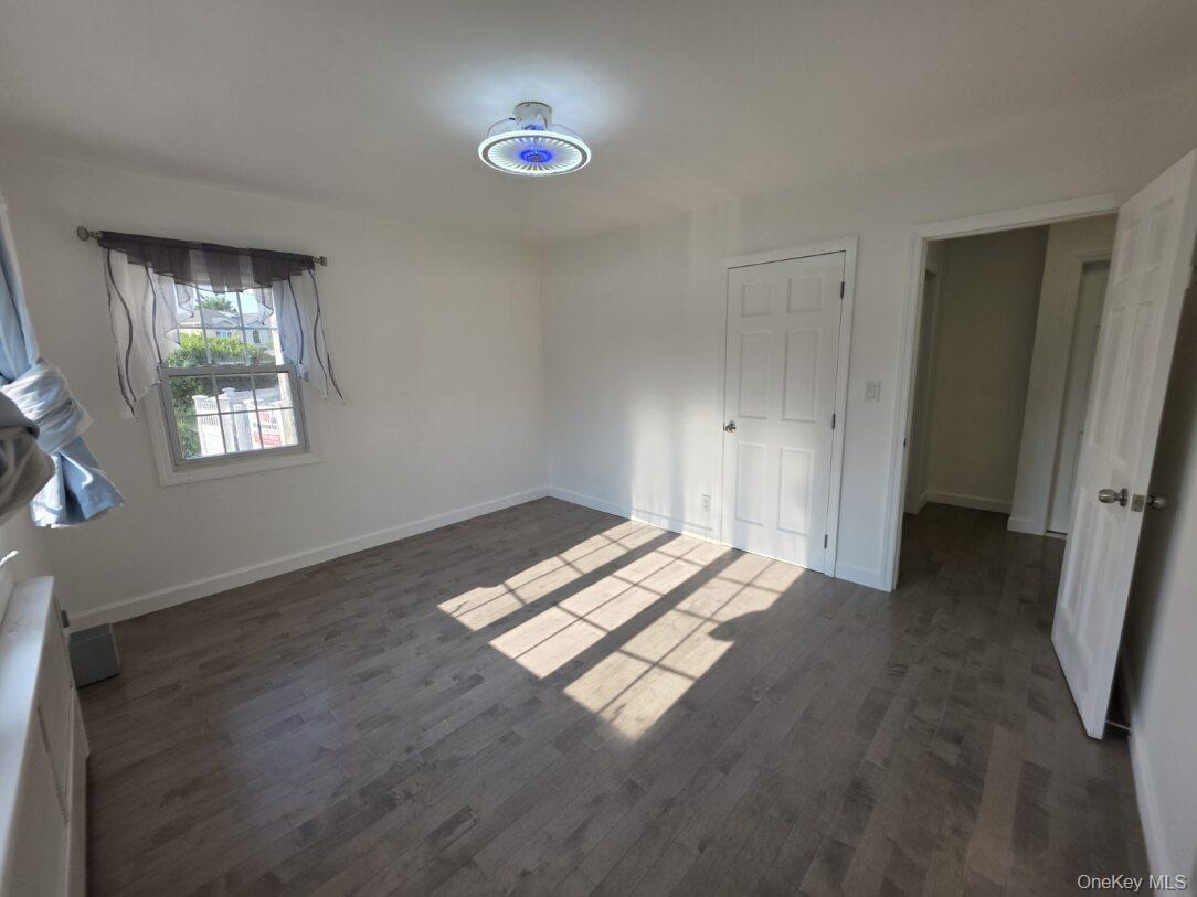 30 Aberdeen Road New Hyde Park, NY 11040 - Photo 5 of 37 a view of empty room with window and wooden floor