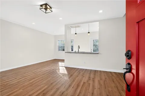 a view of empty room with wooden floor