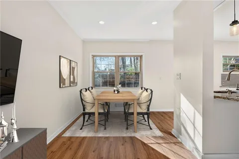 a dining room with furniture and window