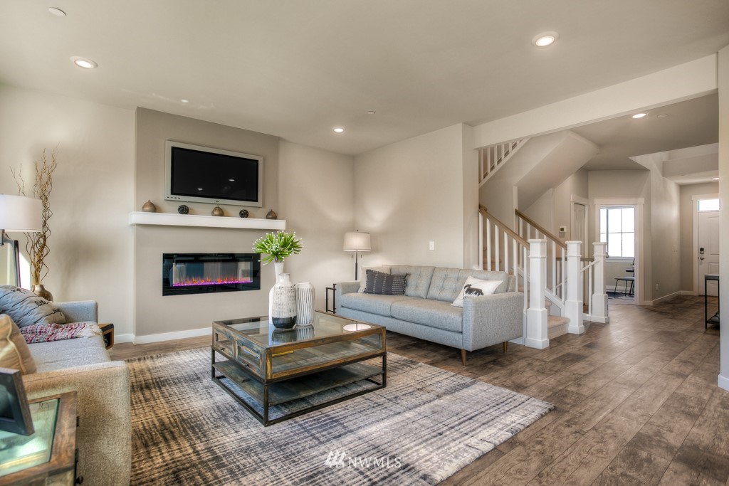 13 180th Place Southeast, Unit 40 Bothell, WA 98012 - Photo 12 of 40 a living room with furniture a flat screen tv and a fireplace