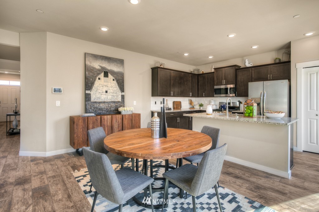 13 180th Place Southeast, Unit 40 Bothell, WA 98012 - Photo 16 of 40 a kitchen with a dining table chairs and refrigerator