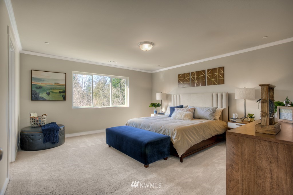 13 180th Place Southeast, Unit 40 Bothell, WA 98012 - Photo 31 of 40 a spacious bedroom with a bed a couch and a window