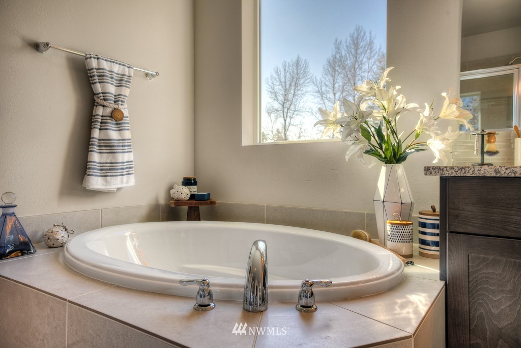 13 180th Place Southeast, Unit 40 Bothell, WA 98012 - Photo 38 of 40 a bath tub sitting in a bathroom next to a window
