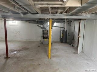 7588 Pelham Road Taylor, MI 48180 - Photo 20 of 20 Unfinished basement with concrete flooring, exposed ceiling joists, and a visible water heater and furnace