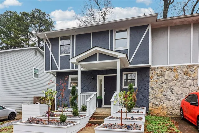 a front view of a house with garden