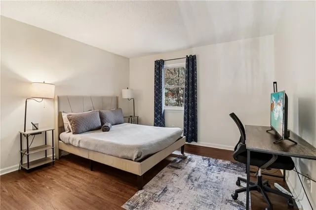 a bedroom with a bed a desk and chair