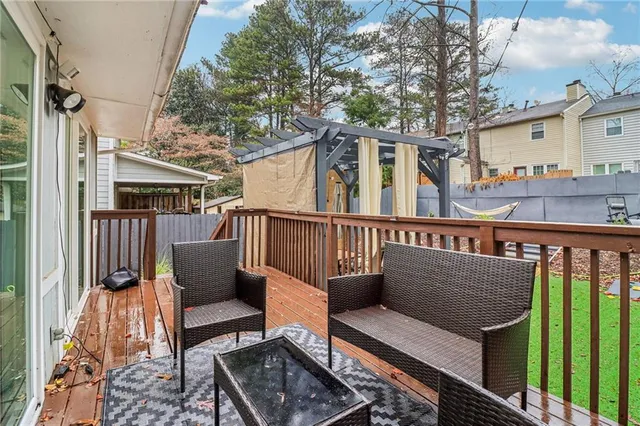 a view of a roof deck with wooden fence and floor