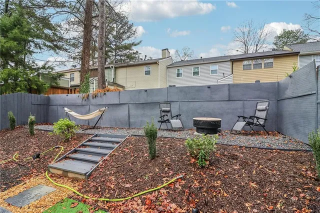 a view of a backyard with plants and outdoor seating