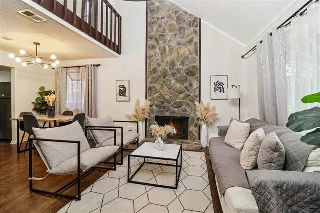 a living room with furniture and a fireplace