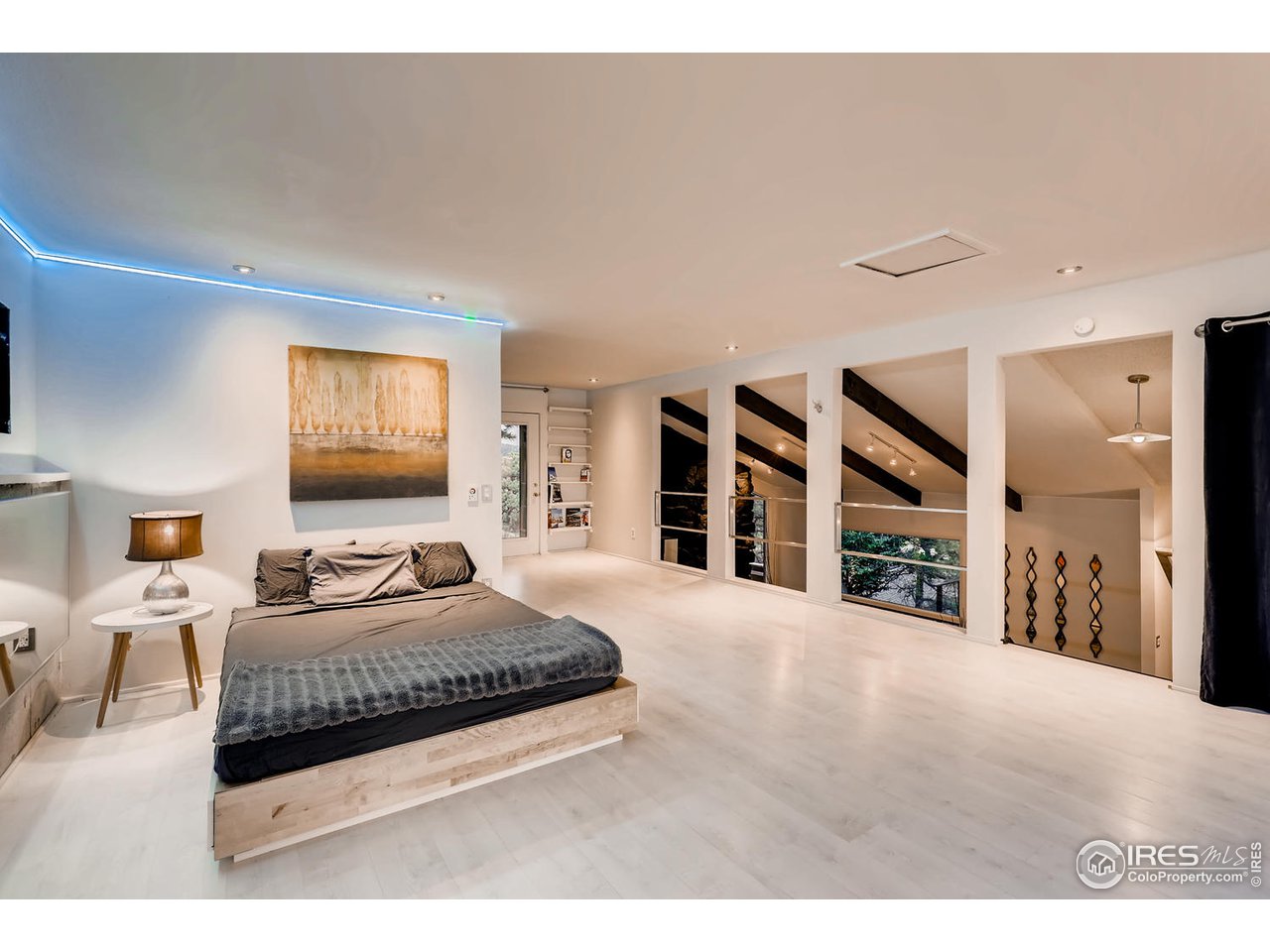 57 Acorn Lane Boulder, CO 80304 - Photo 6 of 40 a bedroom with a large bed and a chandelier