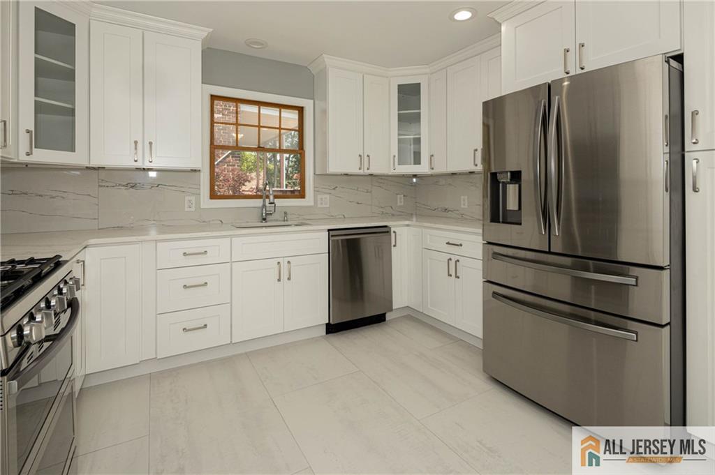 278 Rector Street Perth Amboy, NJ 08861 - Photo 9 of 47 a kitchen with stainless steel appliances a refrigerator sink and microwave