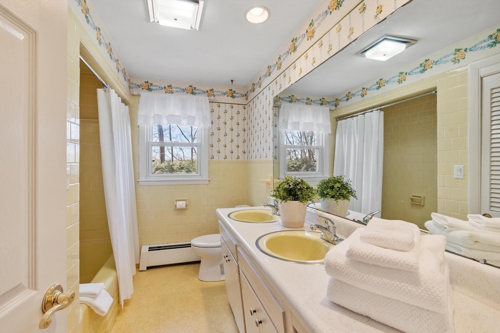 18 Howe Avenue Shrewsbury, MA 01545 - Photo 19 of 42 a spacious bathroom with a granite countertop tub sink and mirror