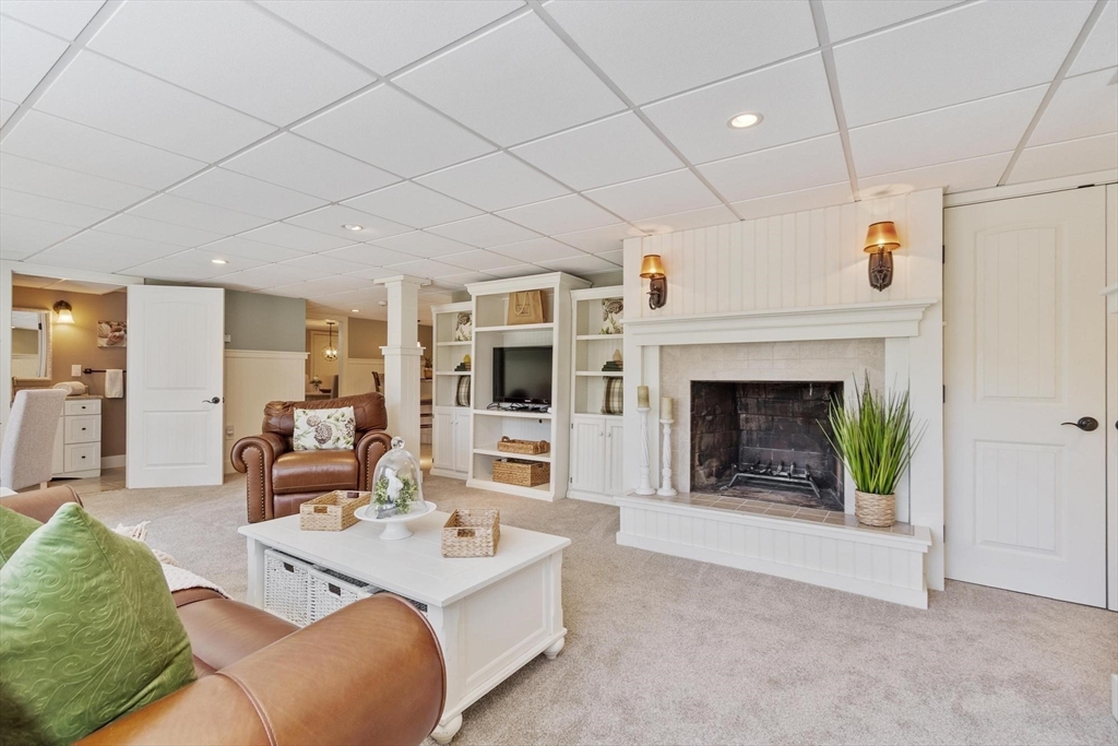 18 Howe Avenue Shrewsbury, MA 01545 - Photo 22 of 42 a living room with furniture and a fireplace