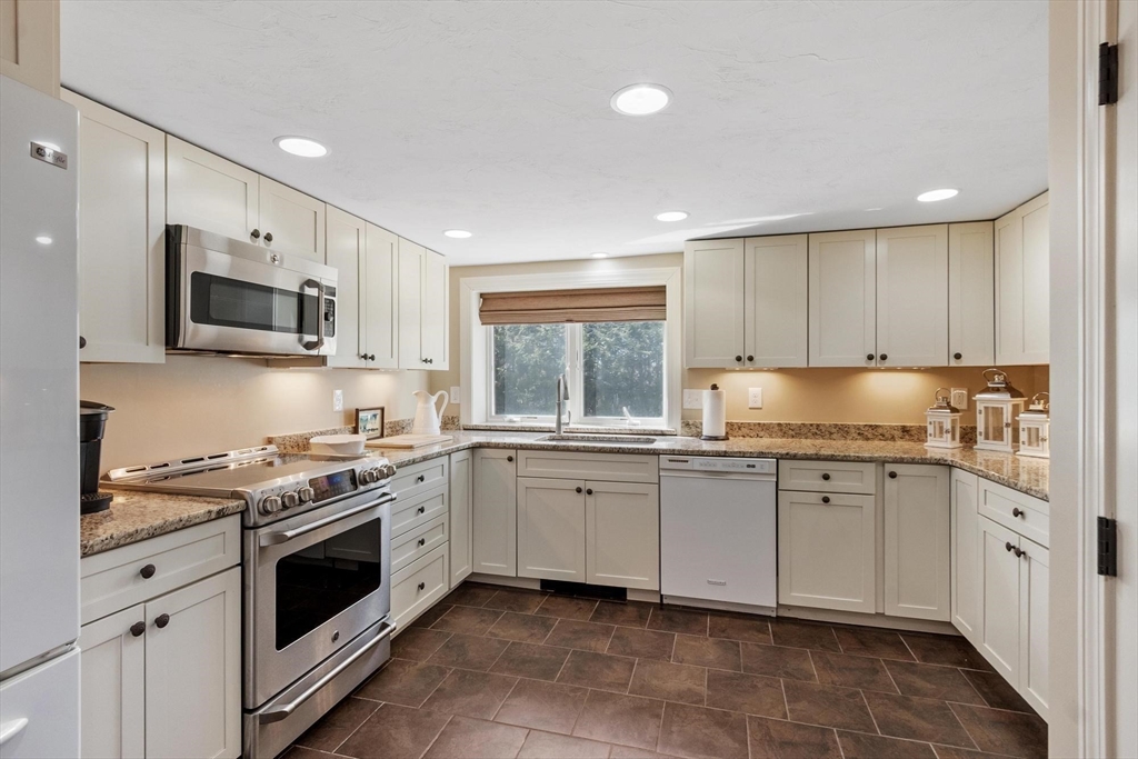 18 Howe Avenue Shrewsbury, MA 01545 - Photo 33 of 42 a kitchen with granite countertop white cabinets white stainless steel appliances a sink and a window