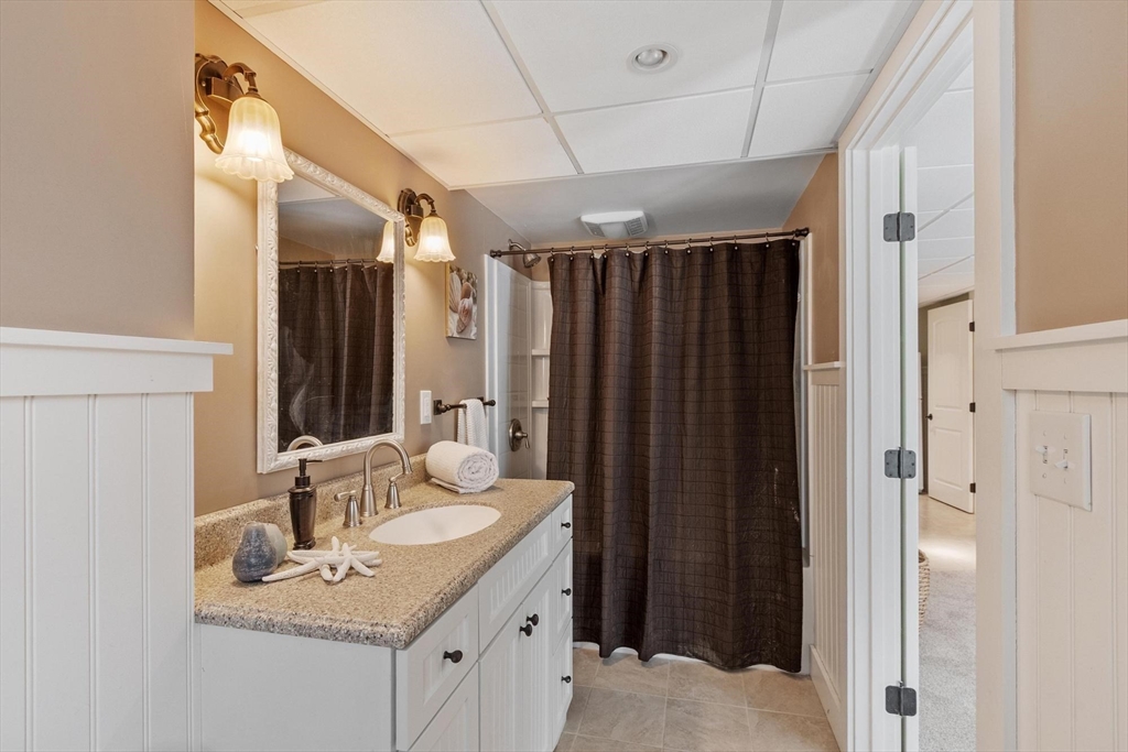18 Howe Avenue Shrewsbury, MA 01545 - Photo 36 of 42 a bathroom with a sink vanity granite and a mirror