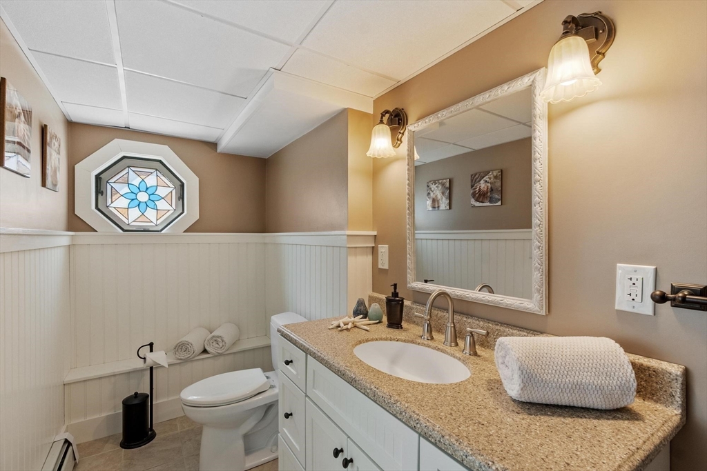 18 Howe Avenue Shrewsbury, MA 01545 - Photo 37 of 42 a bathroom with a granite countertop sink mirror and toilet