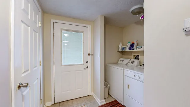 a kitchen with stainless steel appliances granite countertop a stove a sink dishwasher a dining table and chairs with wooden floor