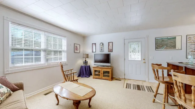 a bathroom with a bathtub shower sink mirror vanity and toilet