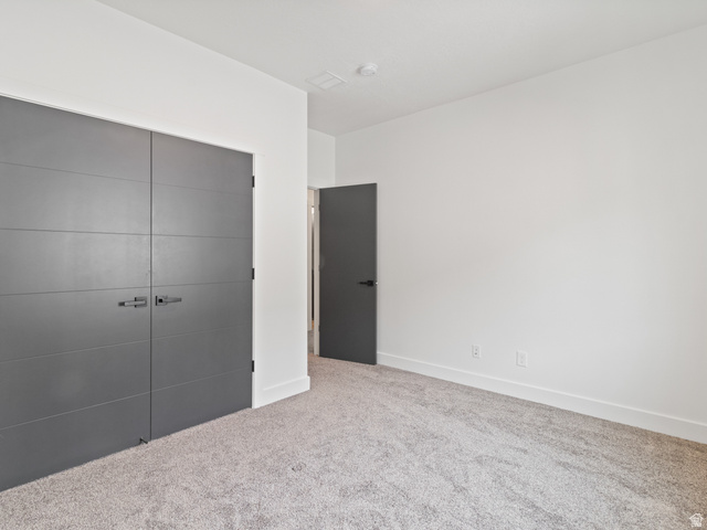 130 East 7085th South, Unit 3 Midvale, UT 84047 - Photo 13 of 30 Unfurnished bedroom featuring a closet and carpet