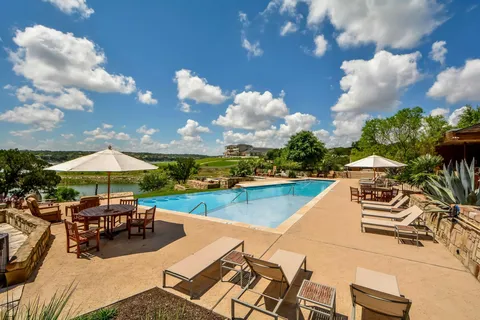 a view of a swimming pool and lounge chairs