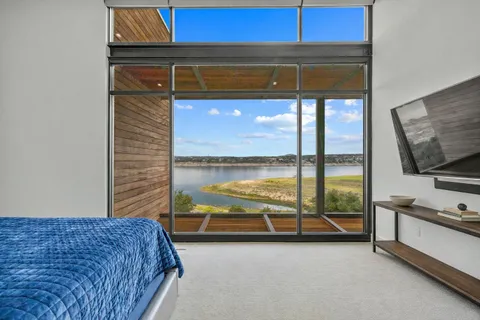 a bedroom with a bed and the view of the window