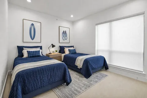 a bathroom with a granite countertop sink a toilet and a mirror