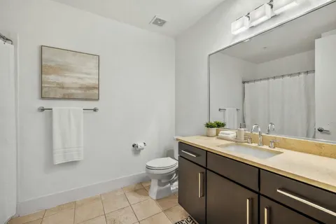 a bed room with a bed and a view of kitchen