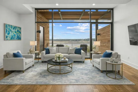 a living room with furniture and a floor to ceiling window