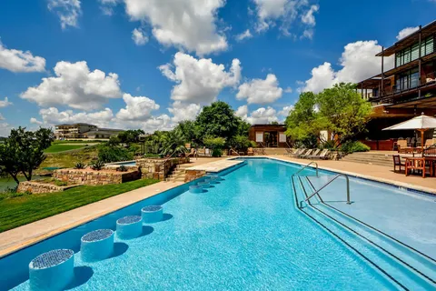 a swimming pool view with a outdoor seating space