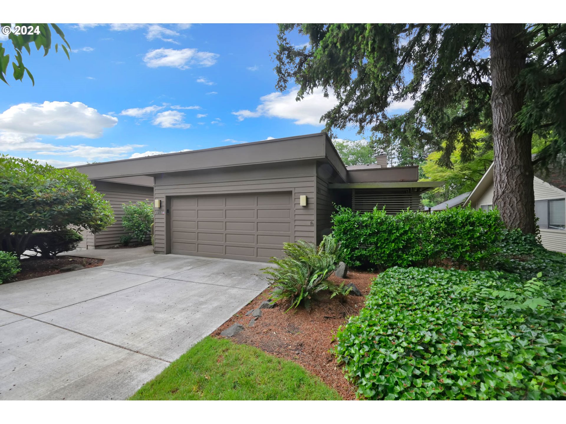 a view of backyard of house with green space