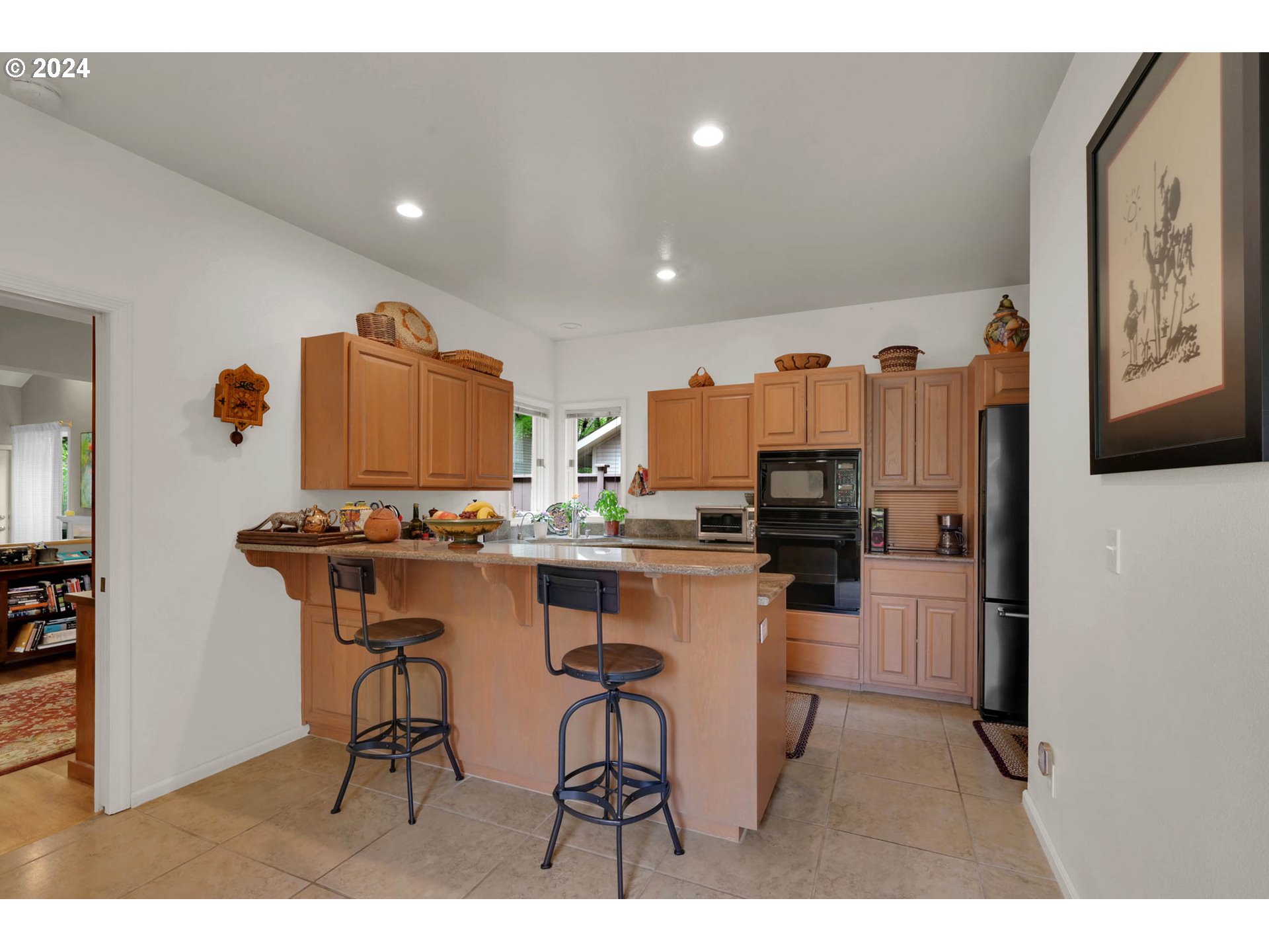 1281 Spyglass Drive Eugene, OR 97401 - Photo 14 of 37 a kitchen with stainless steel appliances kitchen island granite countertop a refrigerator and a stove top oven