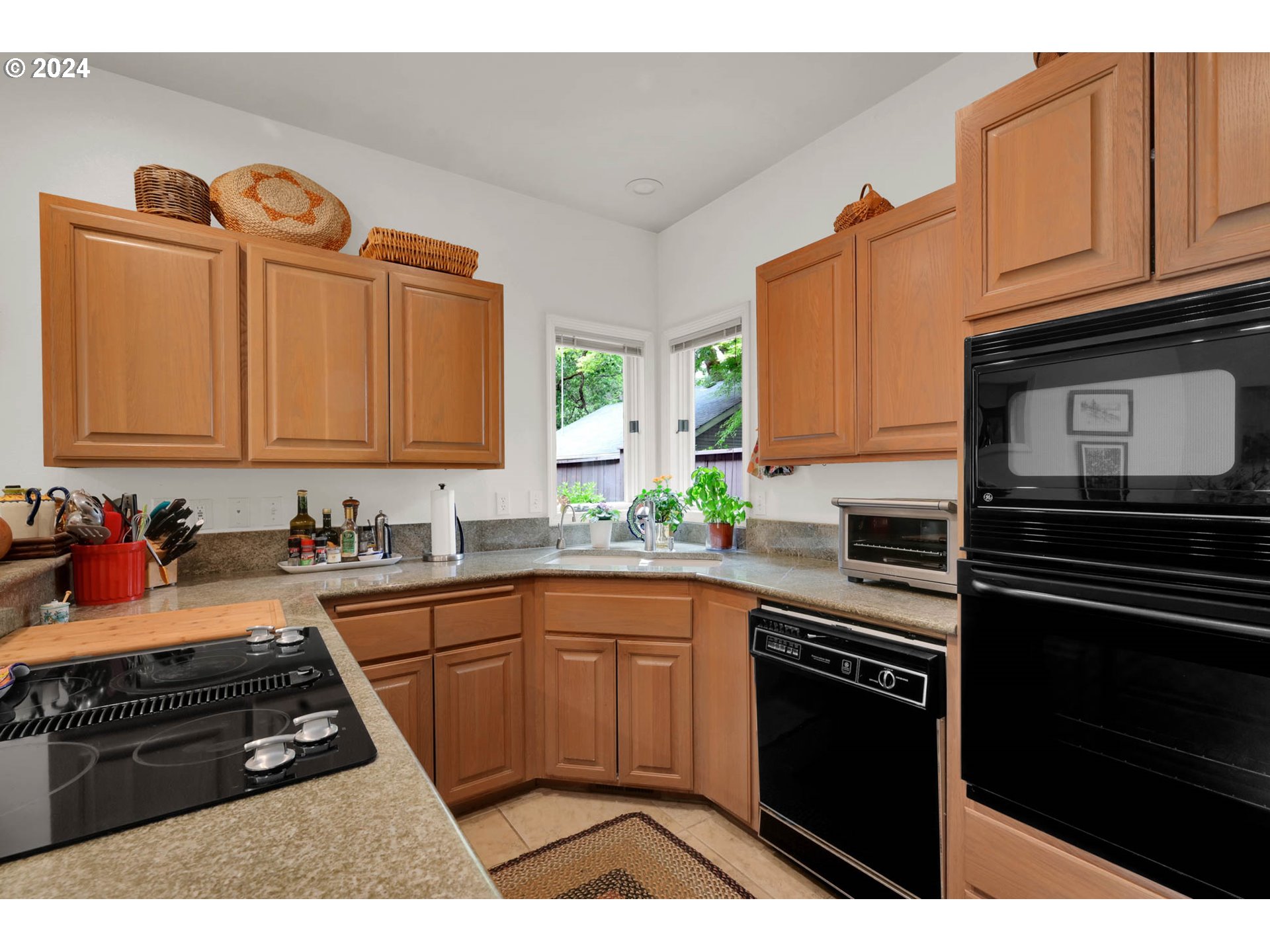 1281 Spyglass Drive Eugene, OR 97401 - Photo 16 of 37 a kitchen with granite countertop a stove sink and cabinets
