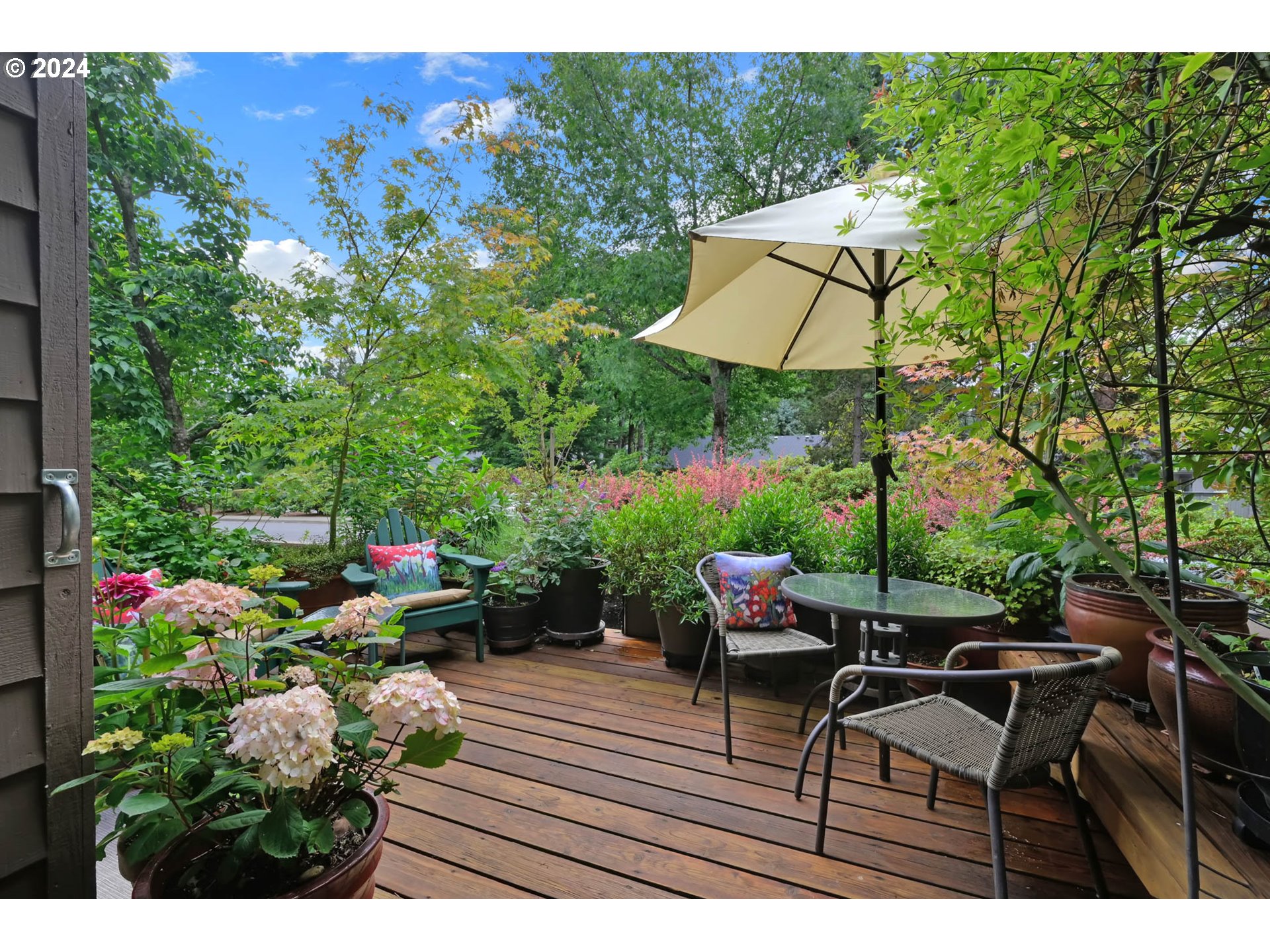 1281 Spyglass Drive Eugene, OR 97401 - Photo 32 of 37 a backyard of a house with table and chairs under an umbrella