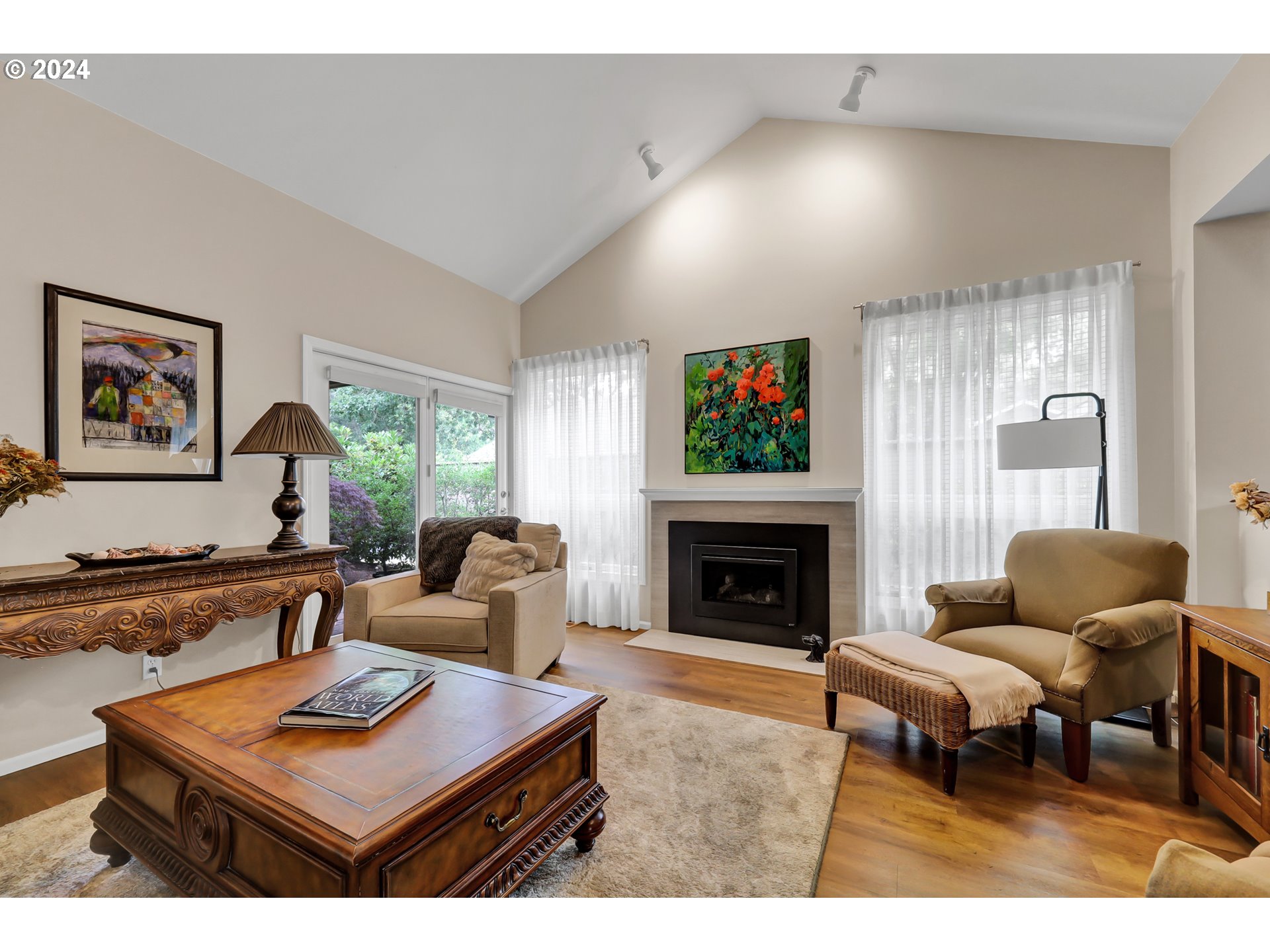 1281 Spyglass Drive Eugene, OR 97401 - Photo 5 of 37 a living room with furniture a flat screen tv and a fireplace