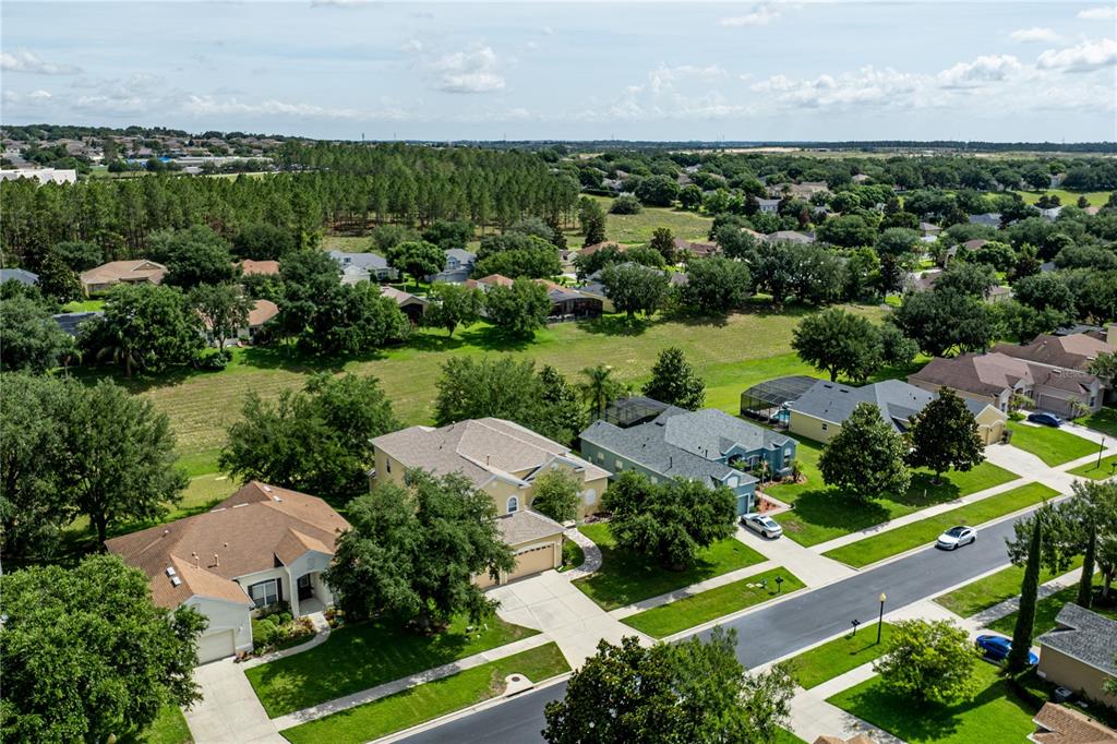 2718 Knightsbridge Road Clermont, FL 34711 - Photo 72 of 72 an aerial view of a houses with a yard