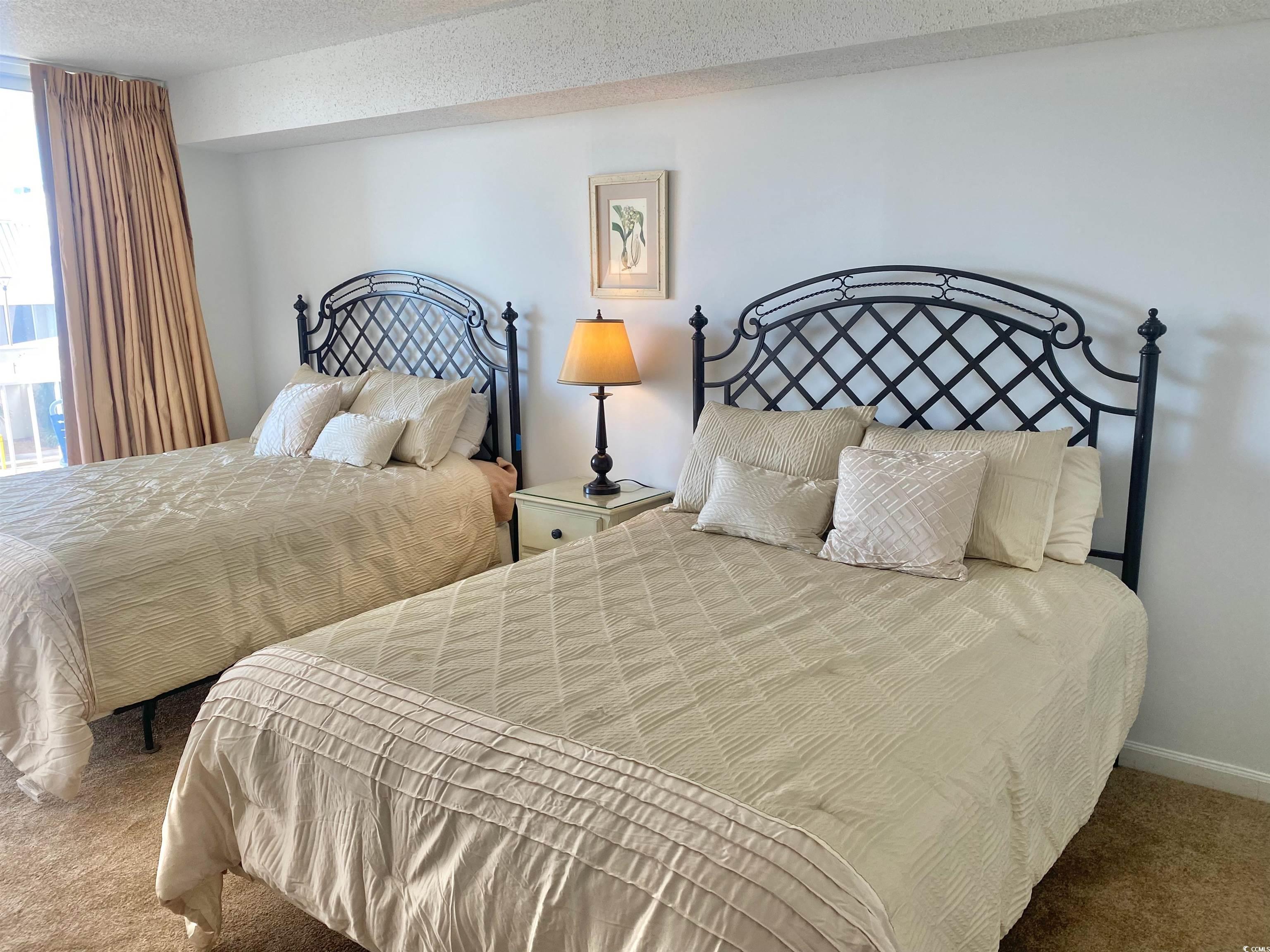 9820 Queensway Boulevard, Unit 206 Myrtle Beach, SC 29572 - Photo 24 of 40 Bedroom with a textured ceiling and carpet flooring