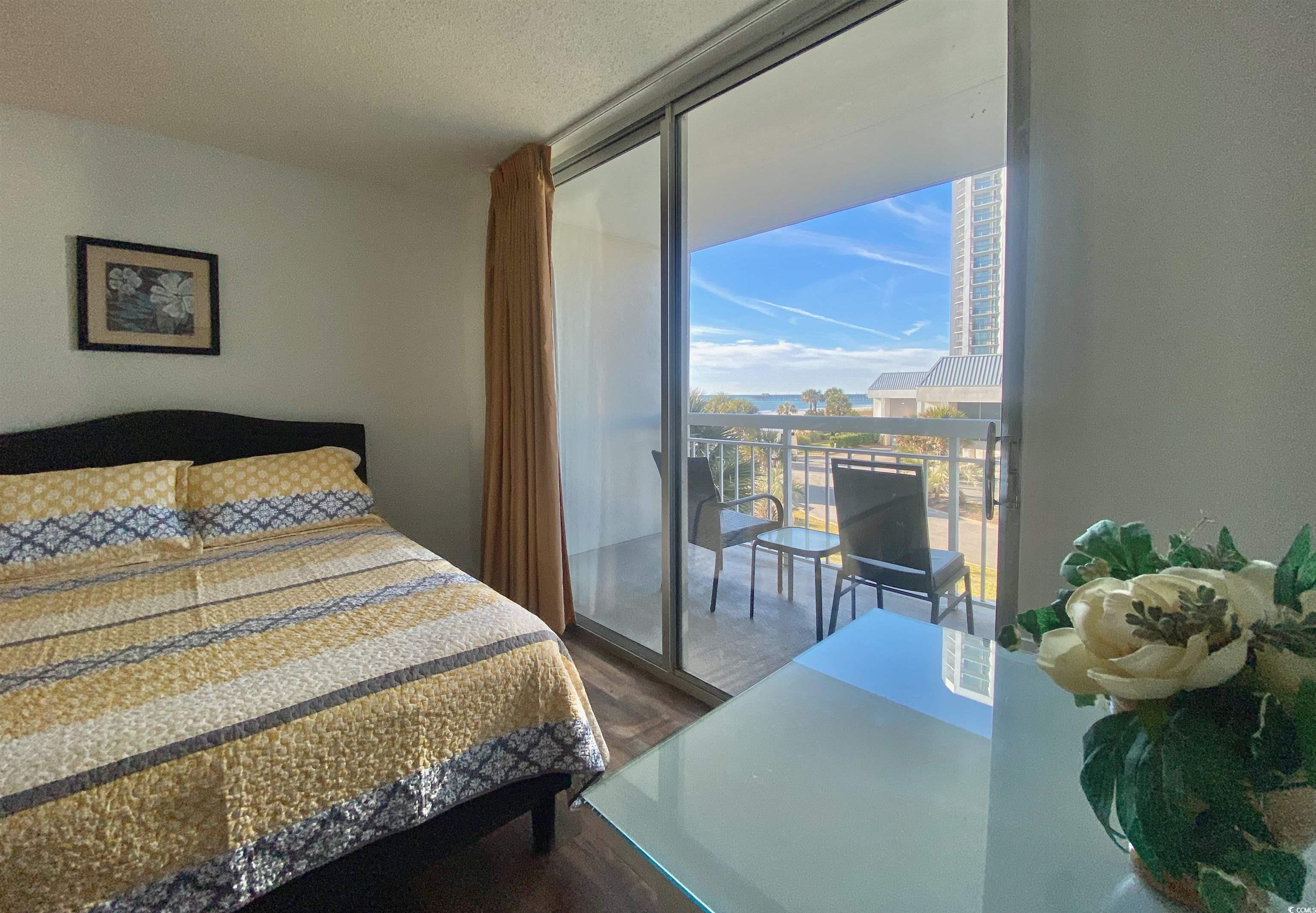 9820 Queensway Boulevard, Unit 206 Myrtle Beach, SC 29572 - Photo 34 of 40 Bedroom with hardwood / wood-style floors and a textured ceiling