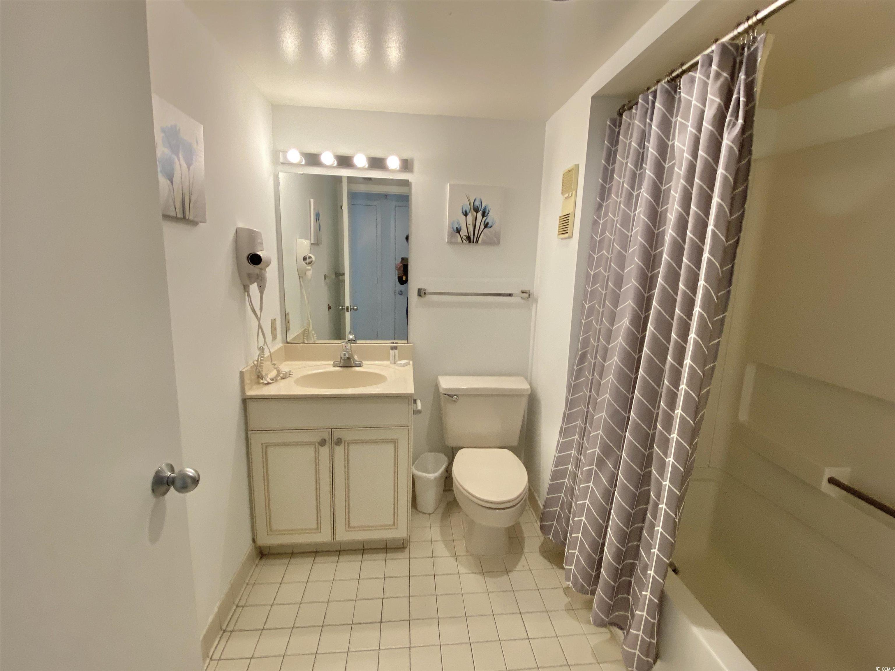 9820 Queensway Boulevard, Unit 206 Myrtle Beach, SC 29572 - Photo 37 of 40 Full bathroom with toilet, tile patterned flooring, shower / tub combo, and vanity