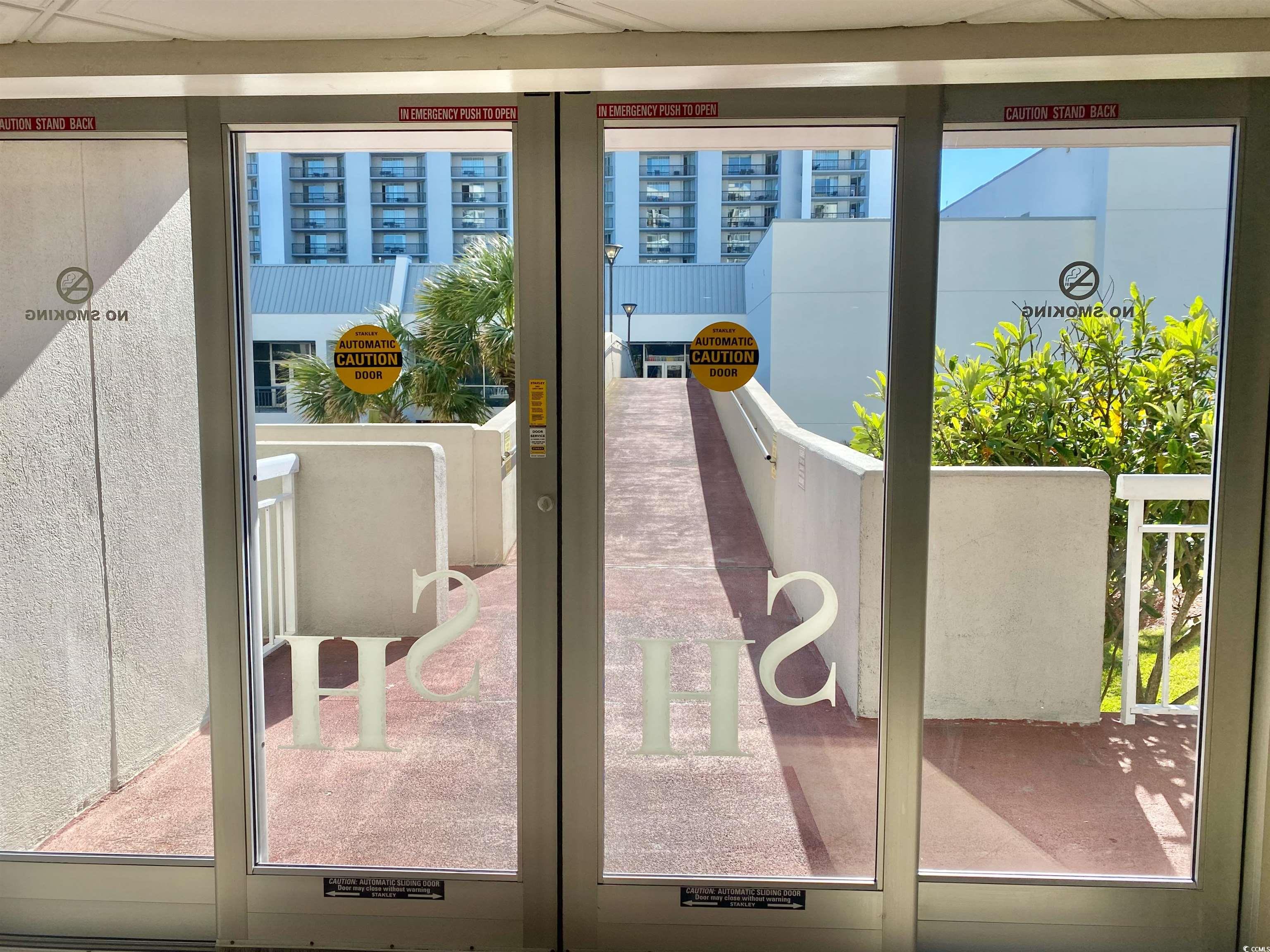 9820 Queensway Boulevard, Unit 206 Myrtle Beach, SC 29572 - Photo 39 of 40 Doorway to outside with a healthy amount of sunlight