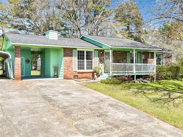 a view of a house with a backyard and porch
