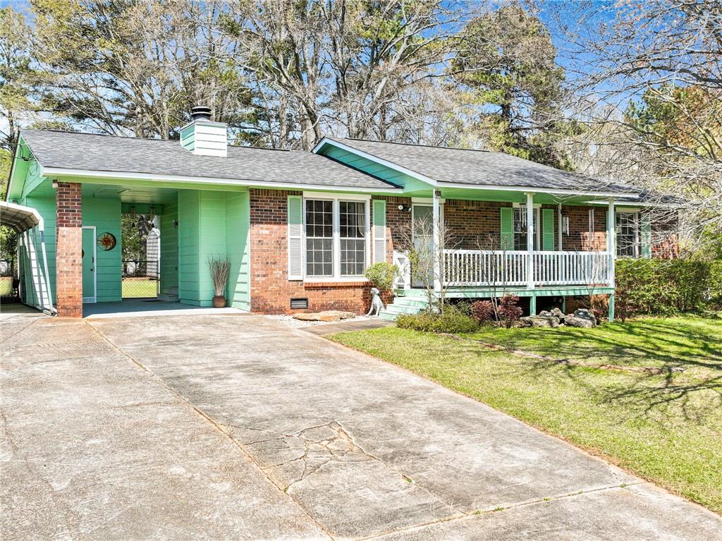 a view of a house with a backyard and porch