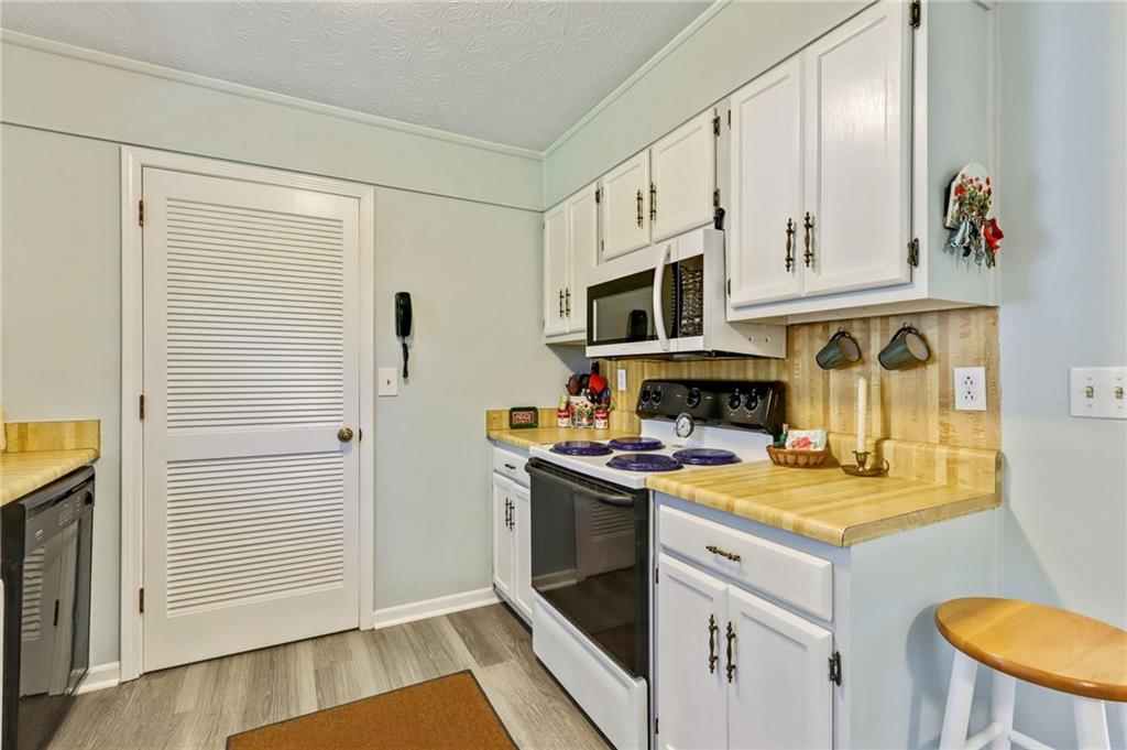4339 Rex Road Rex, GA 30273 - Photo 4 of 23 a kitchen with a stove and a microwave
