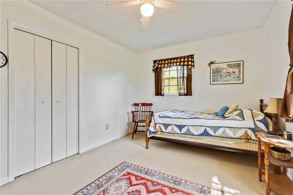 4339 Rex Road Rex, GA 30273 - Photo 10 of 23 a bedroom with a bed and a chandelier