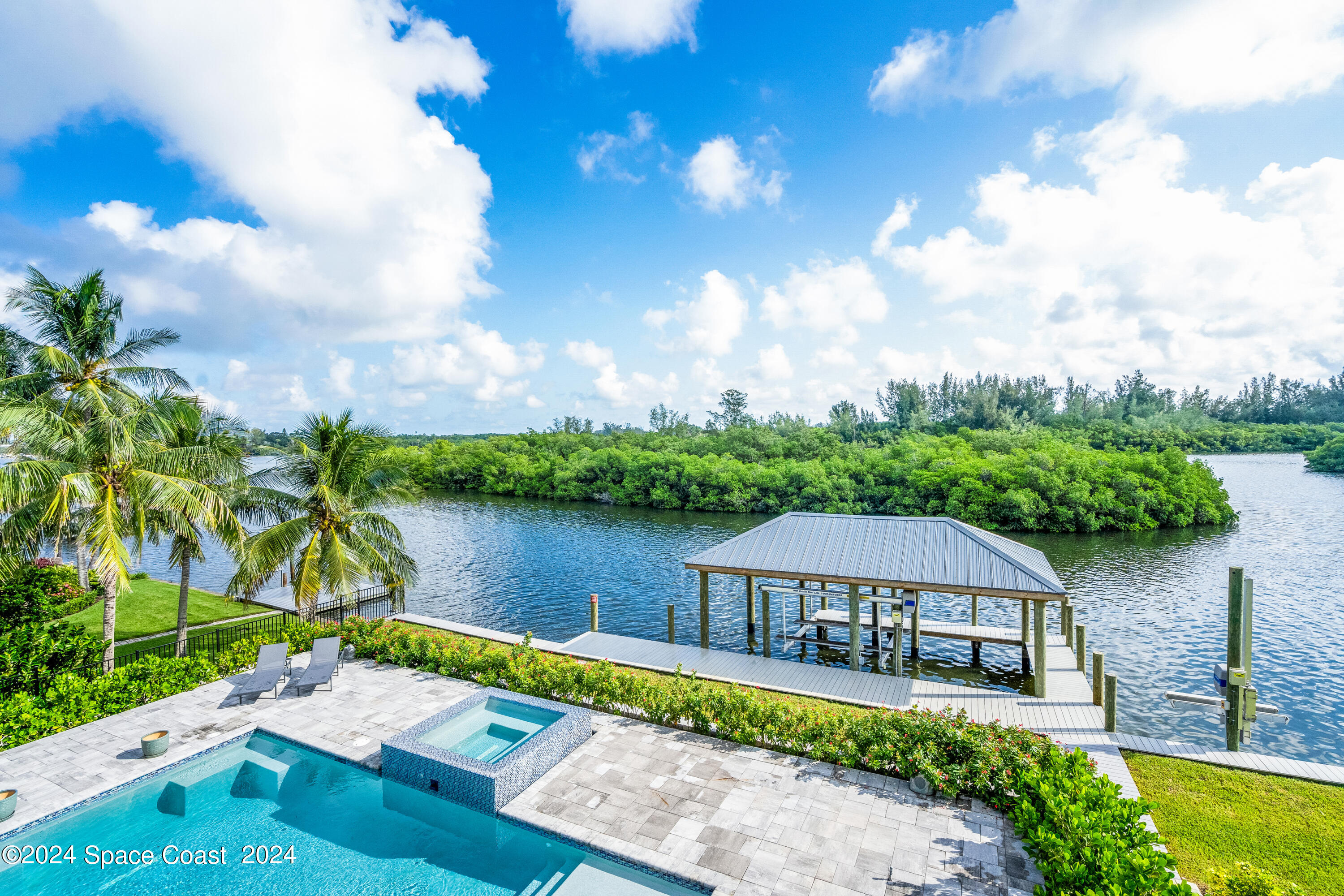 Undisclosed Address Vero Beach, FL 32963 - Photo 1 of 36 a view of a house with a yard and a pond