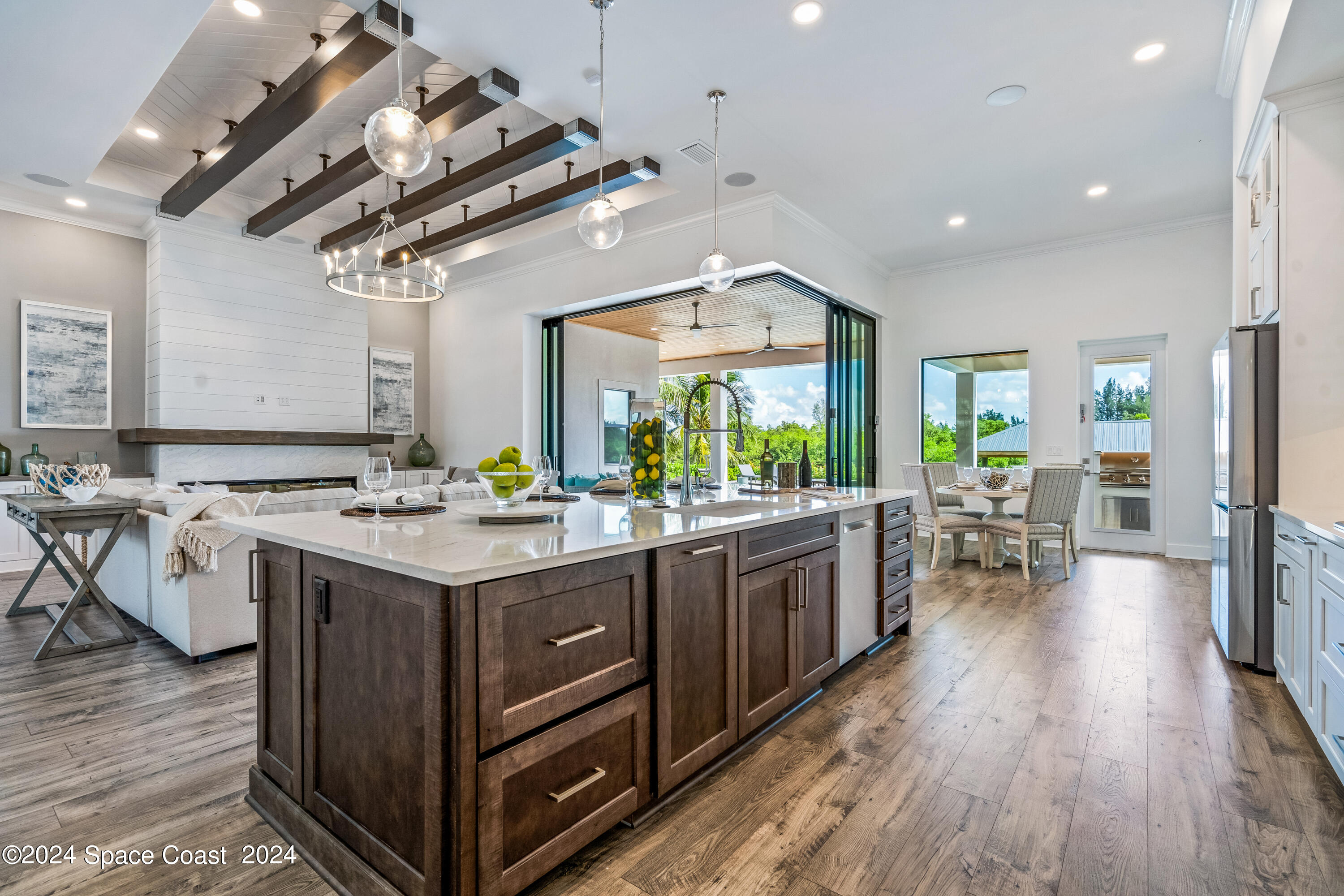Undisclosed Address Vero Beach, FL 32963 - Photo 14 of 36 an open kitchen with a sink stove and wooden floor