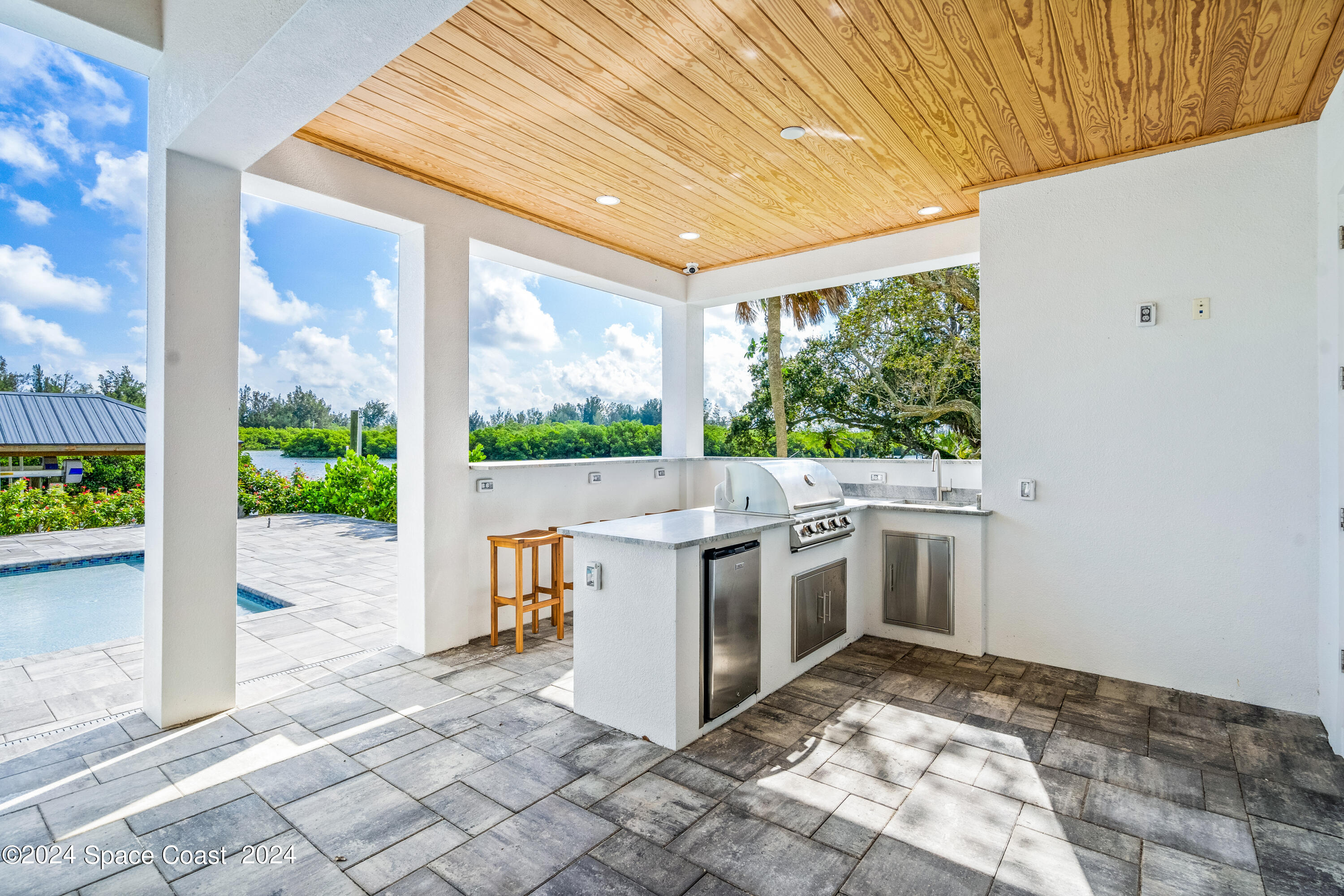 Undisclosed Address Vero Beach, FL 32963 - Photo 18 of 36 a kitchen with a stove a sink and a wooden floors