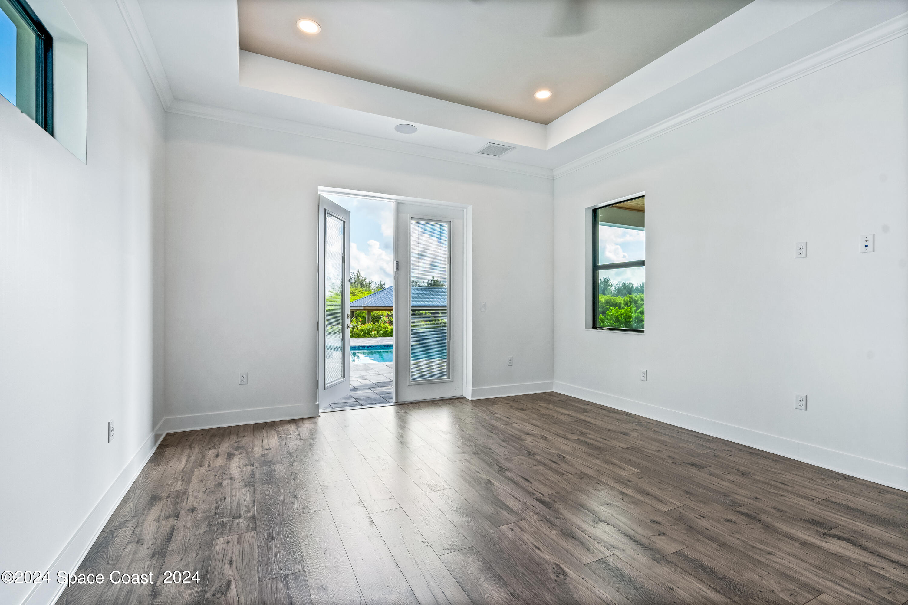 Undisclosed Address Vero Beach, FL 32963 - Photo 24 of 36 an empty room with wooden floor and natural light