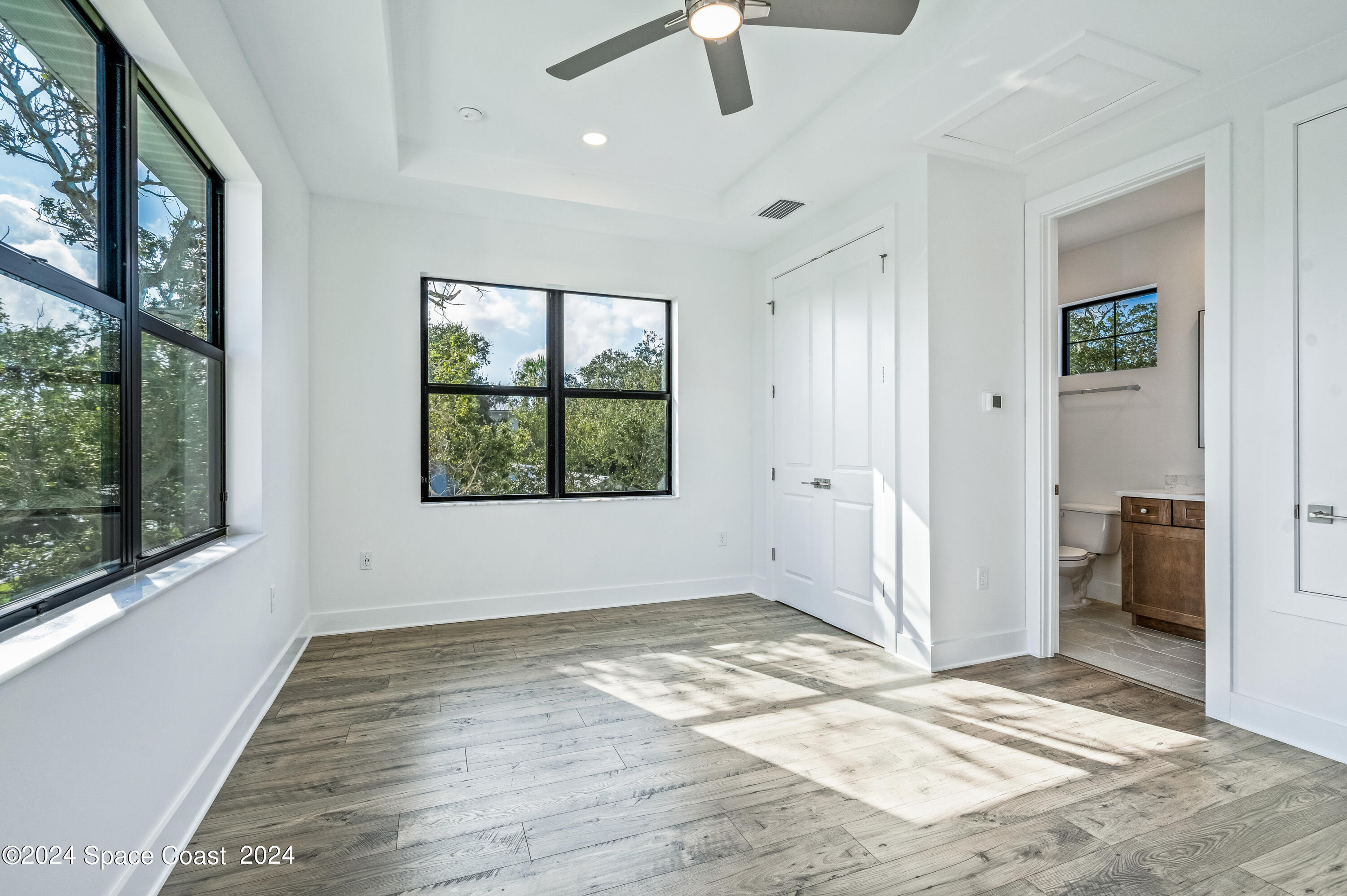 Undisclosed Address Vero Beach, FL 32963 - Photo 30 of 36 a view of an empty room with a window and wooden floor