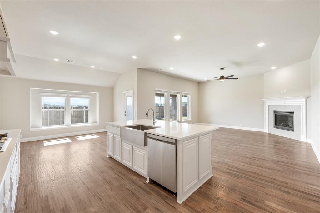 200 Eagle Vw Lane Commerce, TX 75428 - Photo 15 of 34 a kitchen with sink stove and wooden floor